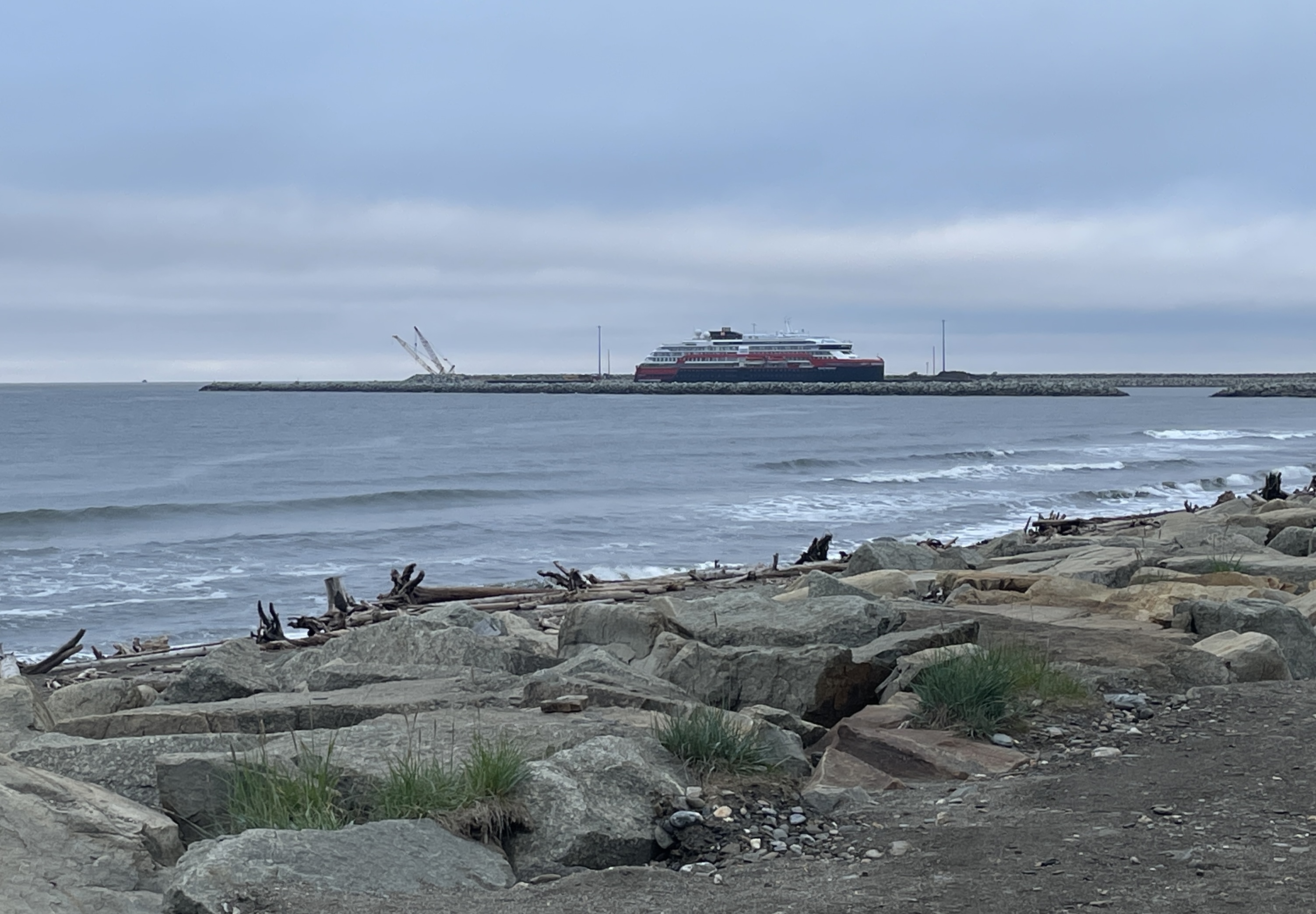 image of the ocean with a cruise ship in the distance 